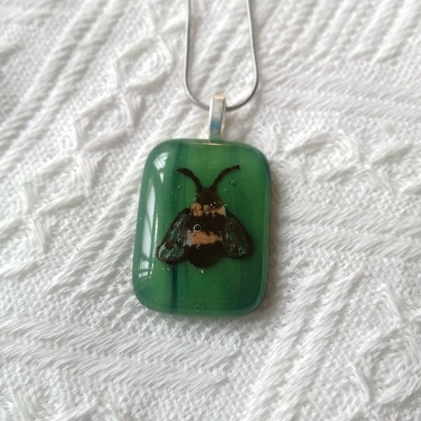 Hand painted bee necklace on green glass