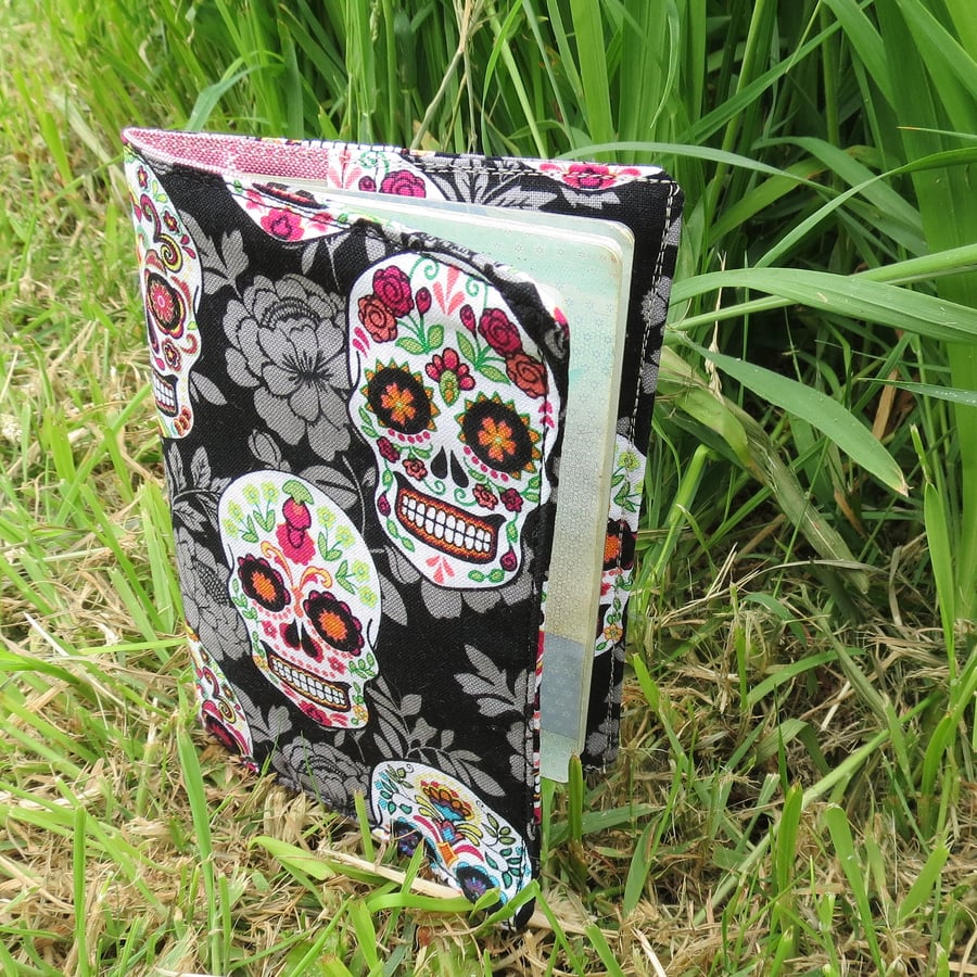 Skulls.  A passport sleeve featuring a skulls and flowers design.