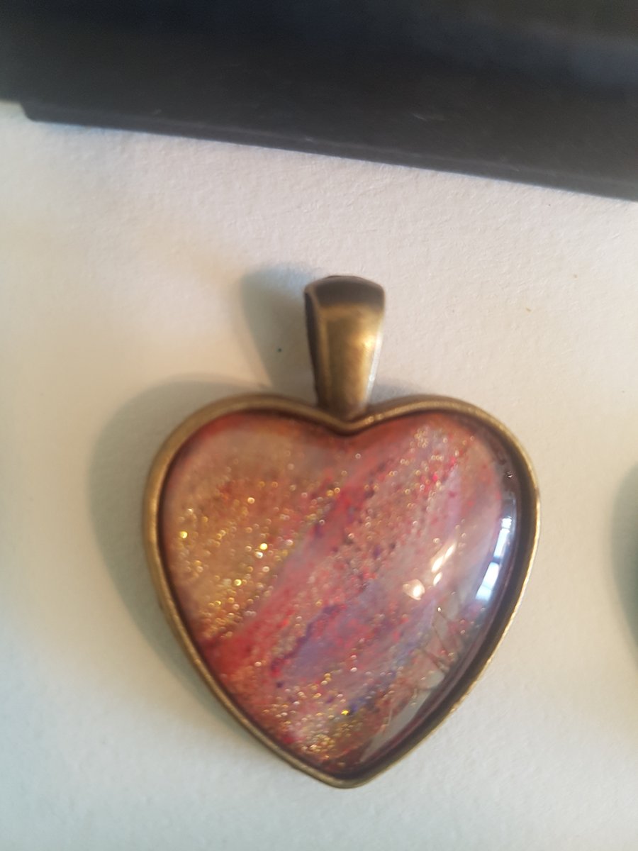 Heart shaped pendant, tones of brushed gold mauve and crimson