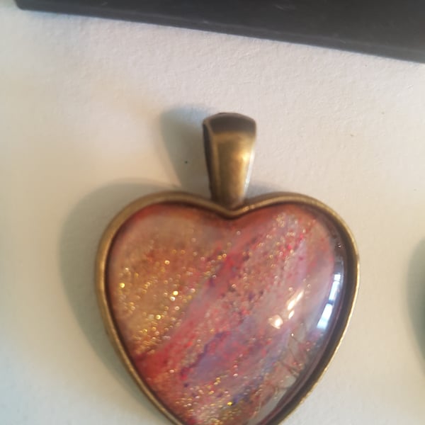 Heart shaped pendant, tones of brushed gold mauve and crimson