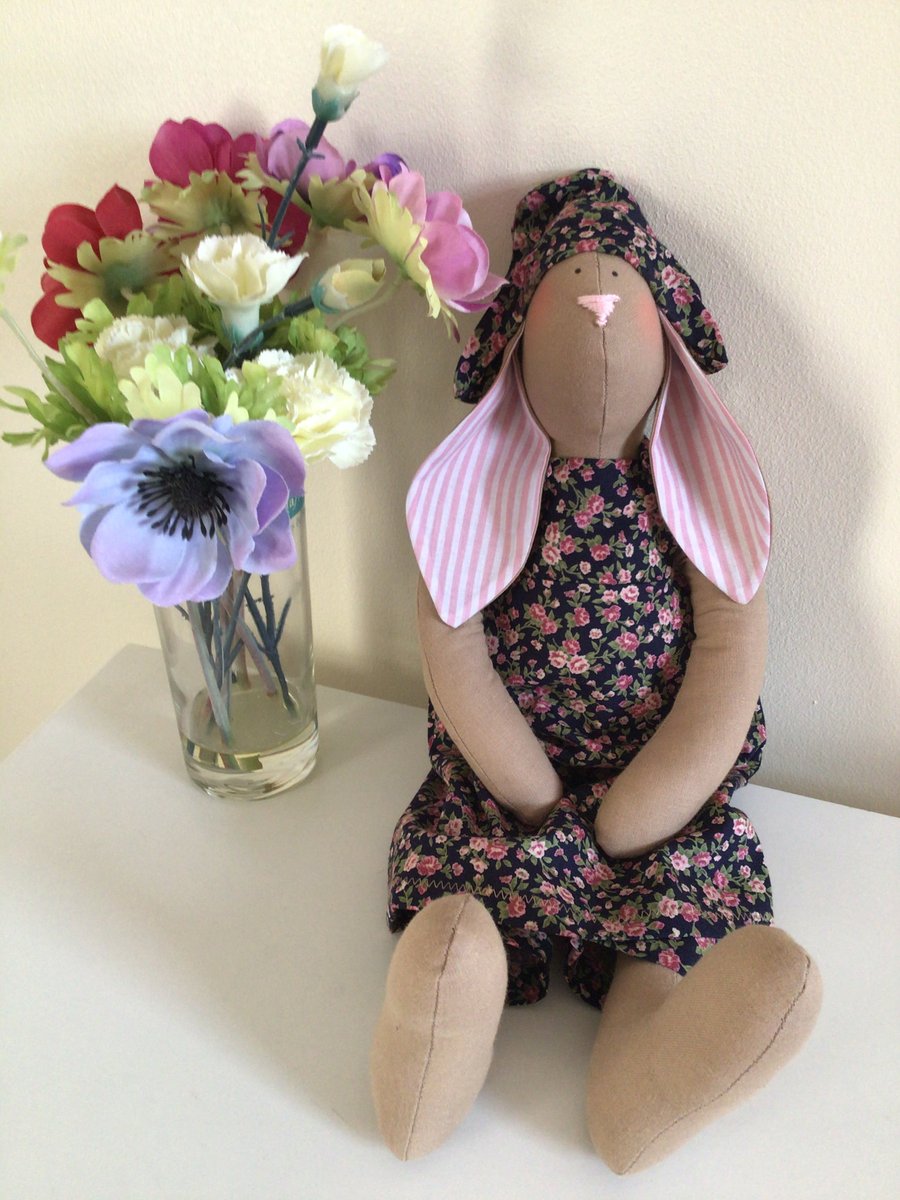 Rabbit Doll in pink floral outfit.