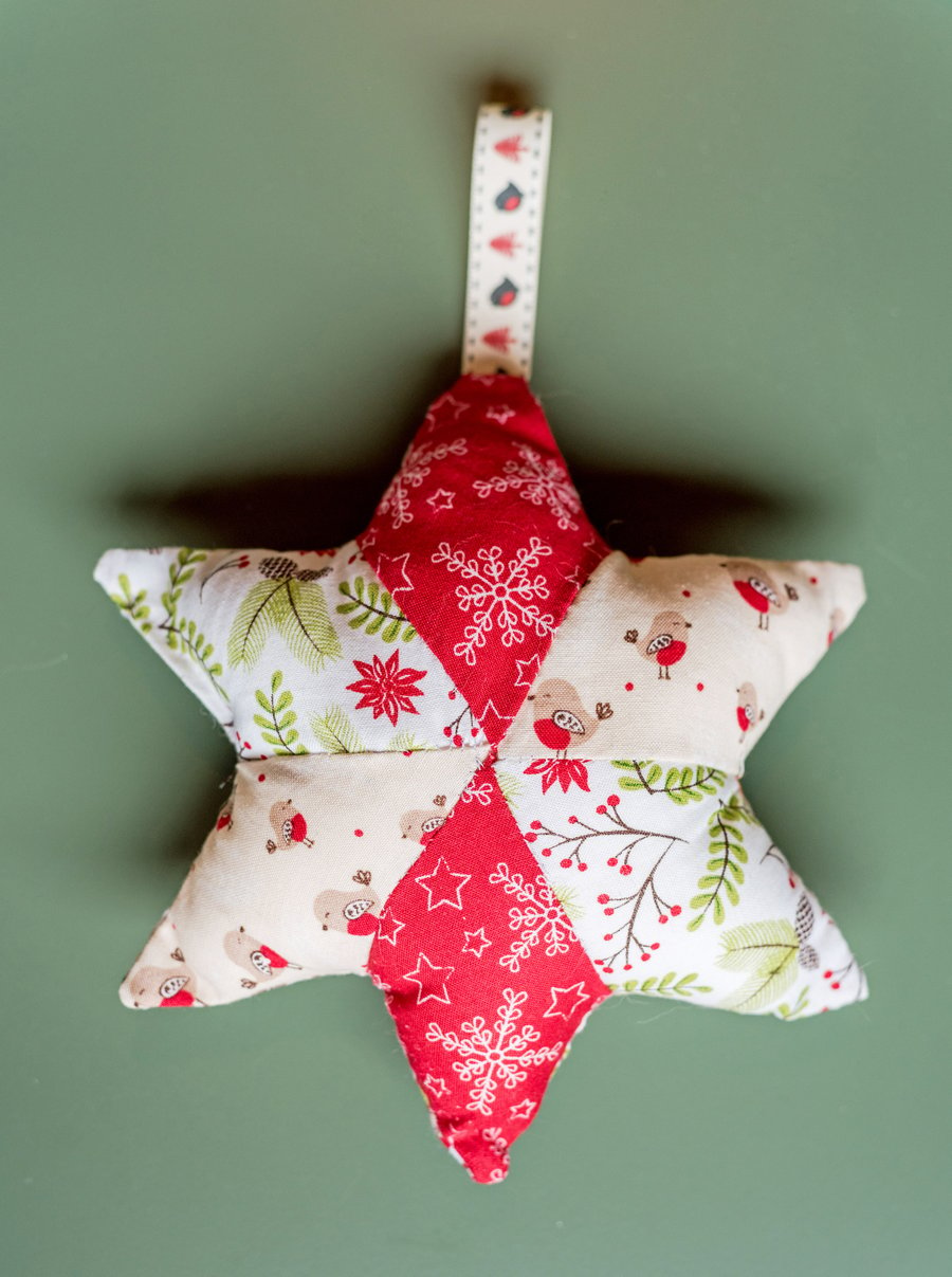 Christmas star decoration with robins, holly, and snowflakes