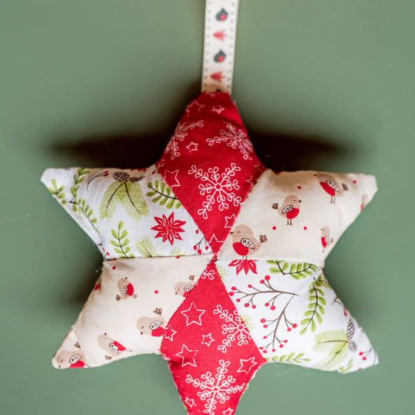 Christmas star decoration with robins, holly, and snowflakes