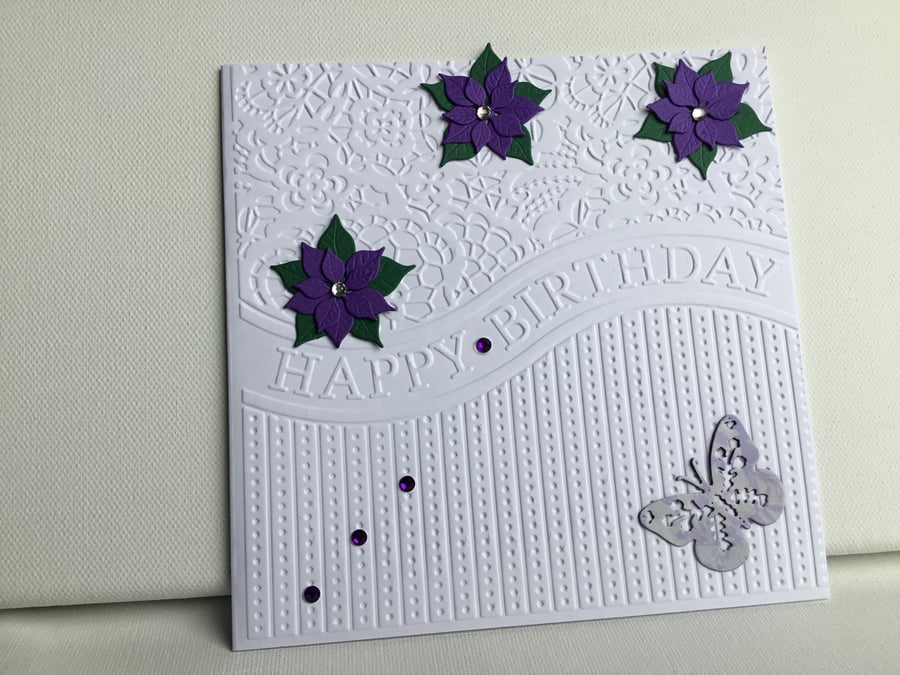 Poinsettia and butterfly embossed Birthday card. CC409