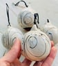 Set of four black and white swirled pebble baubles.  - Image 1