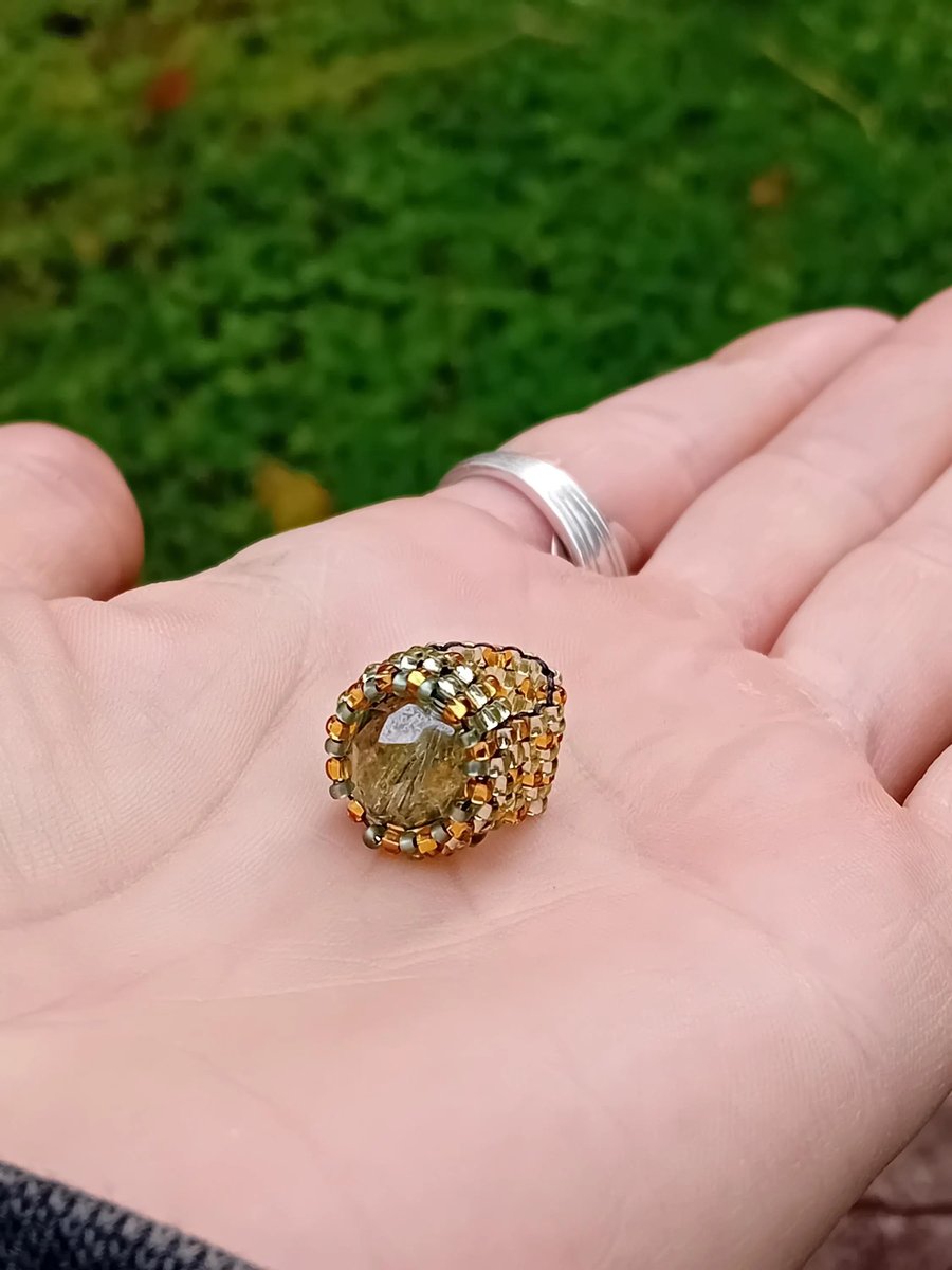 Gold and glittering green dragon eye beaded dreadlock cuff