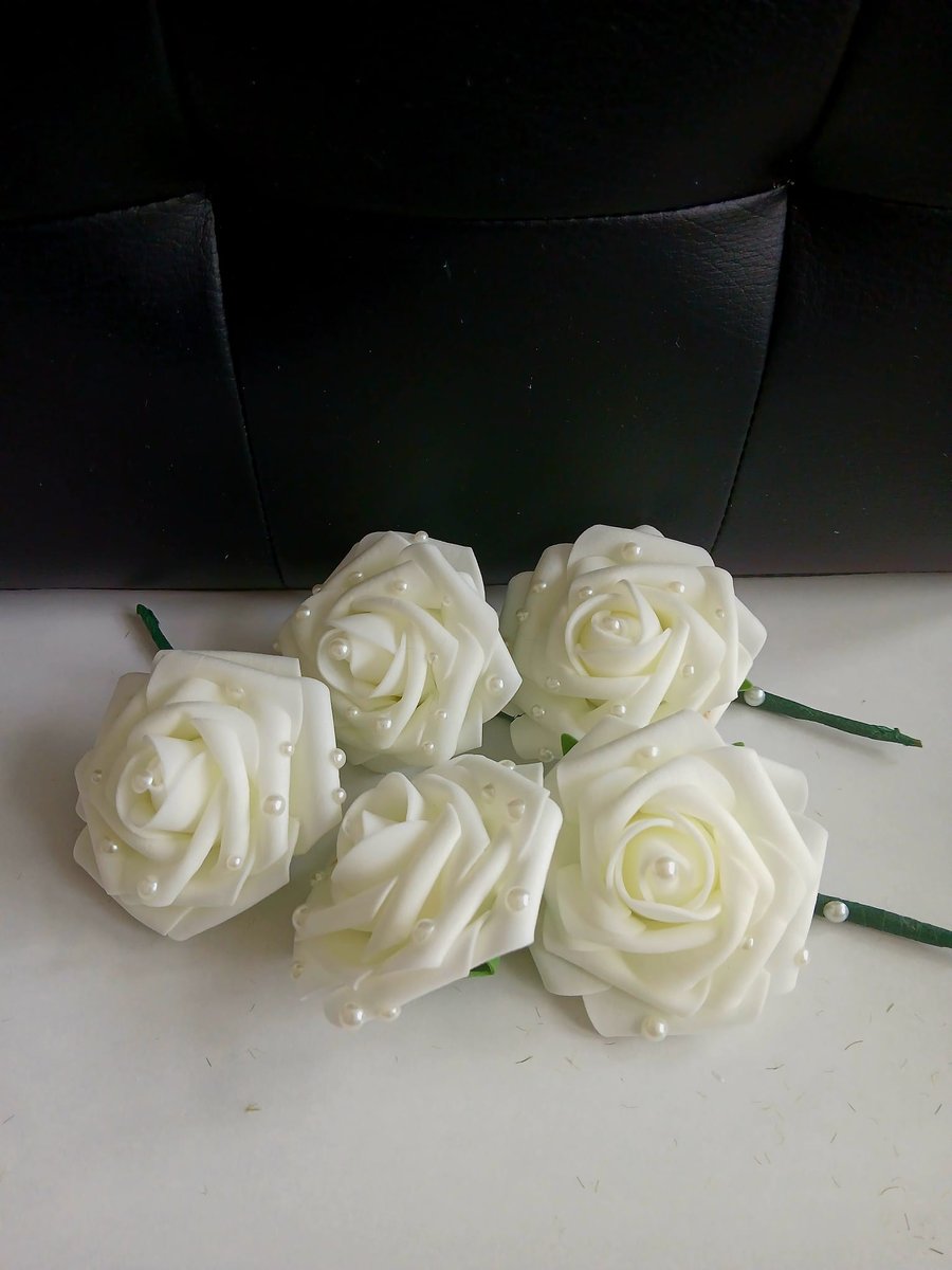 Cream rose buttonholes with pearl detail. 