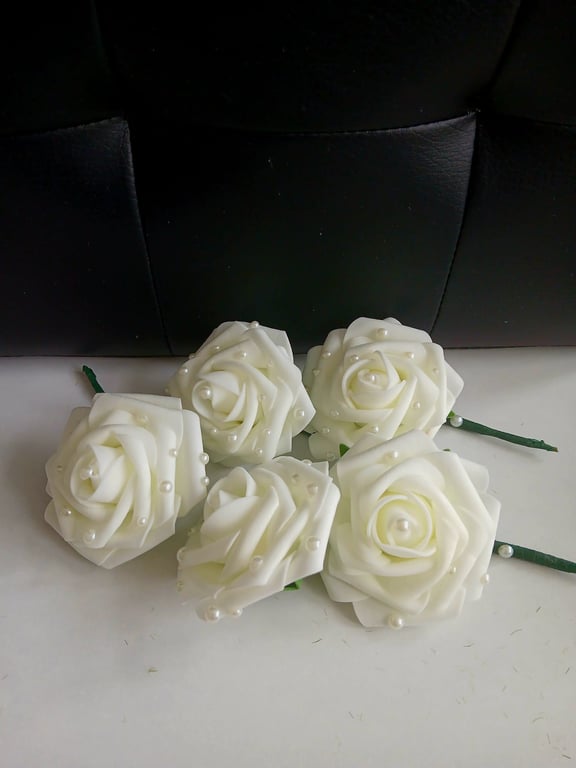 Cream rose buttonholes with pearl detail. 