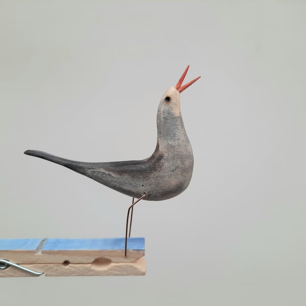 Pecking peg bird