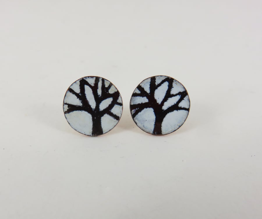 Round copper stud earrings with hand drawn tree motif.