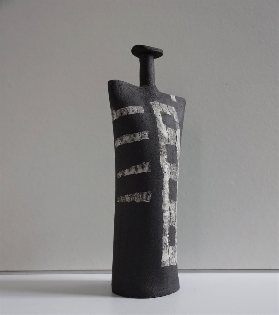 Hespera.  Abstract ceramic art form in black stoneware with white motifs.