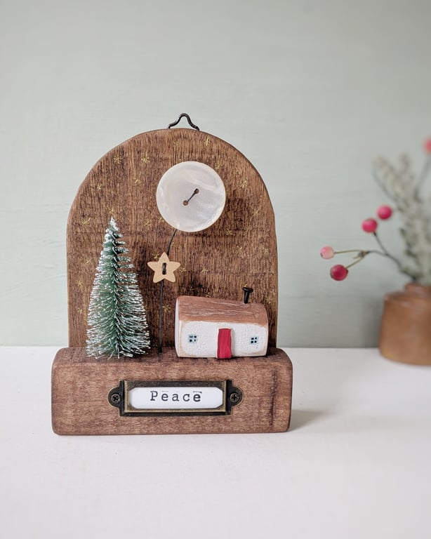 Festive Wooden Cottage Scene with Star and Moon