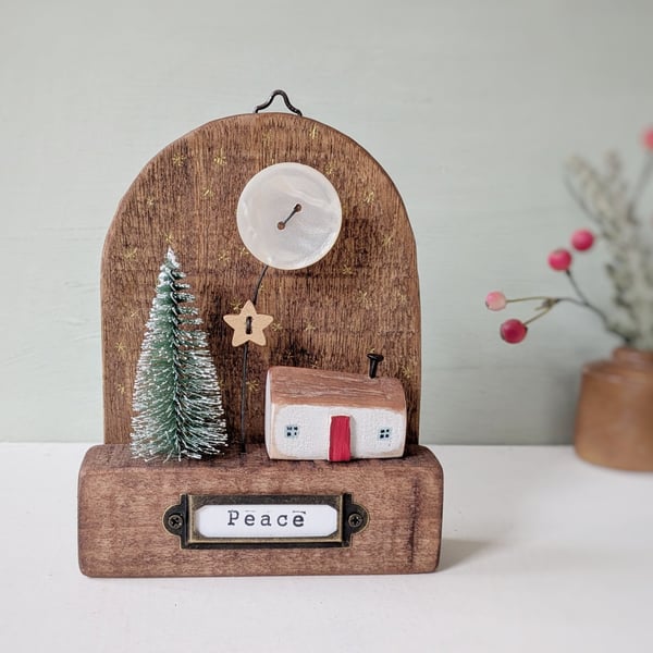 Festive Wooden Cottage Scene with Star and Moon
