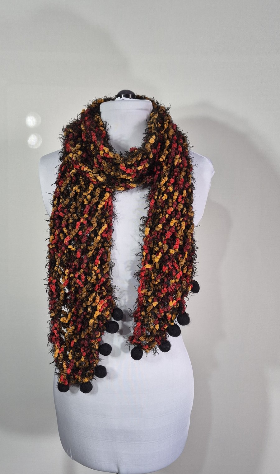 Long Thin Handknitted Scarf in Black Orange And Red With Hand Felted Baubles .