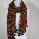 Long Thin Handknitted Scarf in Black Orange And Red With Hand Felted Baubles .