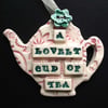 Ceramic teapot decoration with button flower
