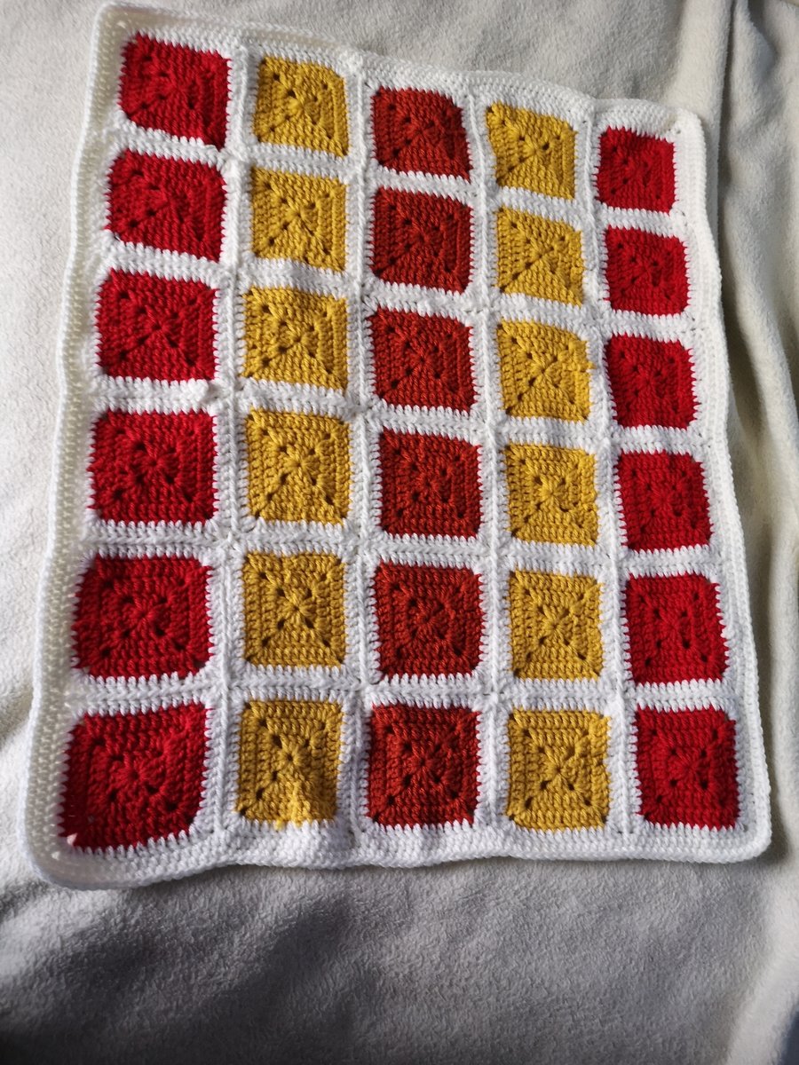 Red, yellow and white crochet blanket