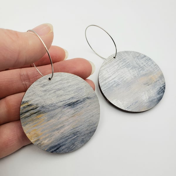 Large modern unique earrings with a touch of shimmering gold and silver
