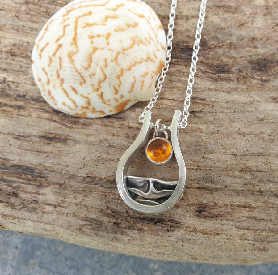 Silver and amber sun rising over sea pendant with amber