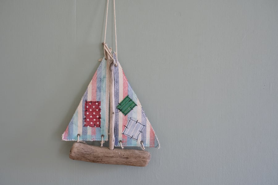 Embroidered driftwood boat
