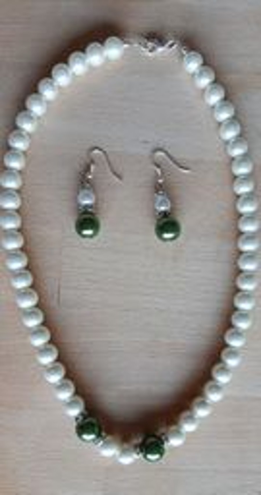 White pearl necklace with green pearls