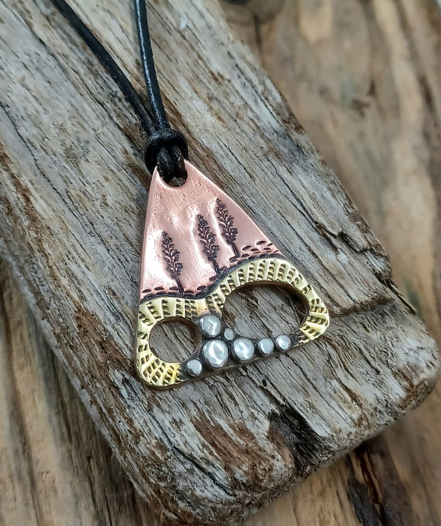 Copper, brass and silver 'abstract' landscape pendant 