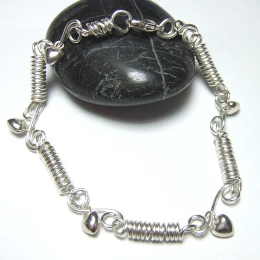 Handmade sterling silver bracelet with heart charms