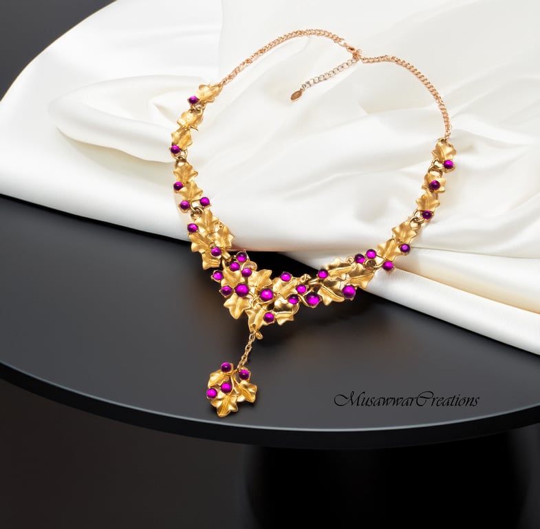 Handcrafted Gold-Plated Leaf Motif Necklace Adorned with Magenta Beads,
