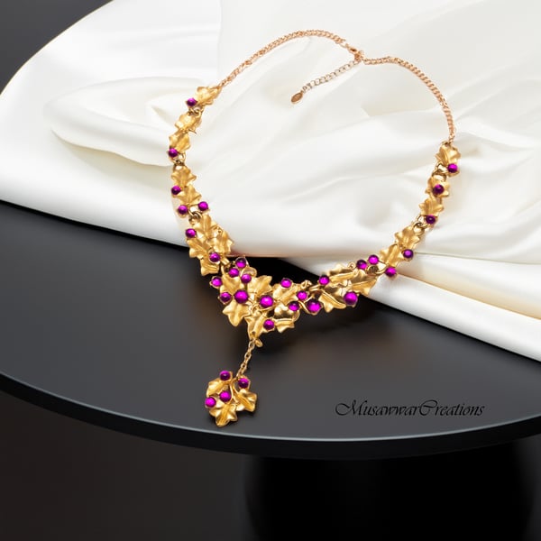 Handcrafted Gold-Plated Leaf Motif Necklace Adorned with Magenta Beads,