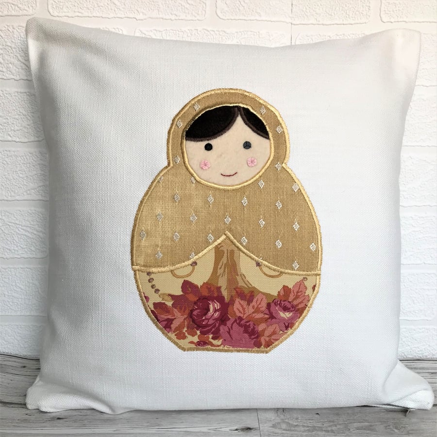Russian doll cushion in cream with gold and pink Russian doll