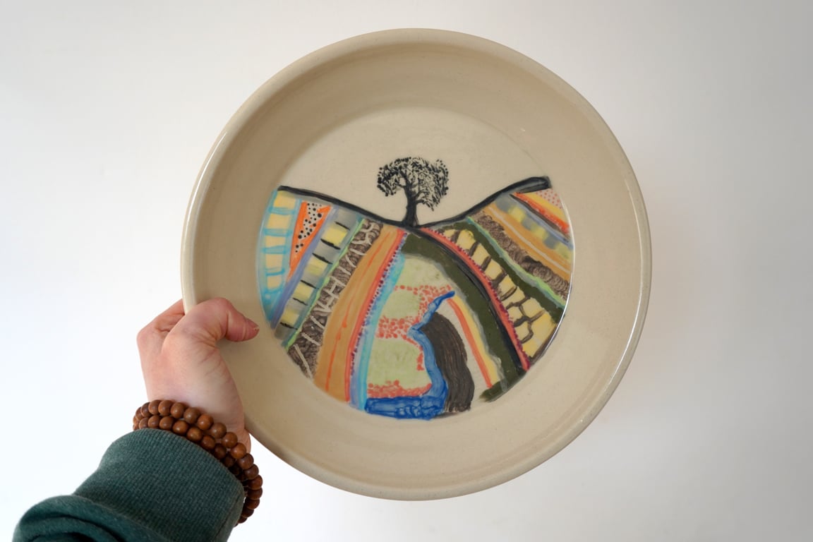 Hand thrown stoneware plate with painted country field scene
