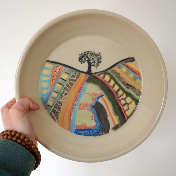 Hand thrown stoneware plate with painted country field scene