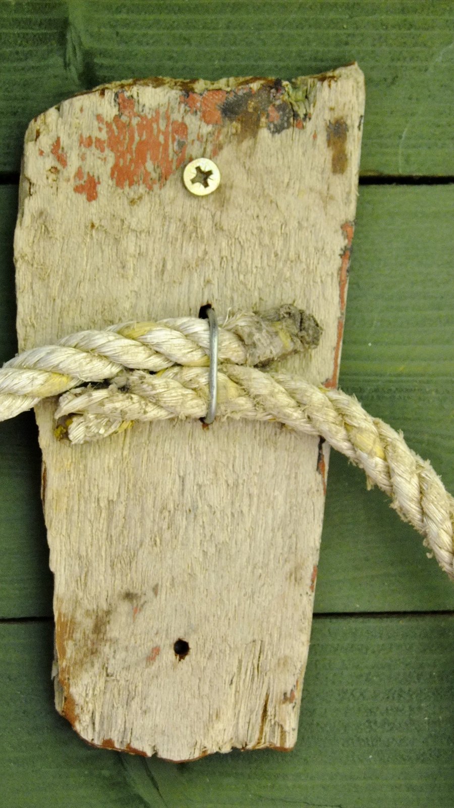 Rustic driftwood towel holder for bathroom or toilet with old rope.