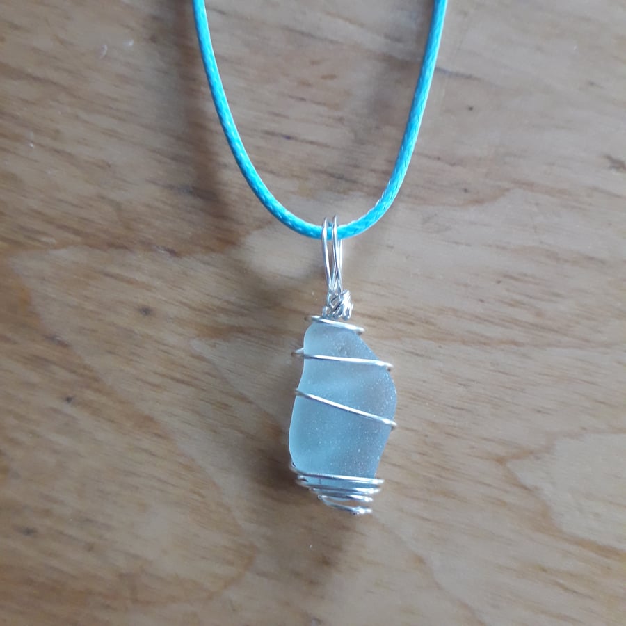 Ice Blue Grey Sea Glass Necklace, Silver Wire Wrapped Pendant on blue cord