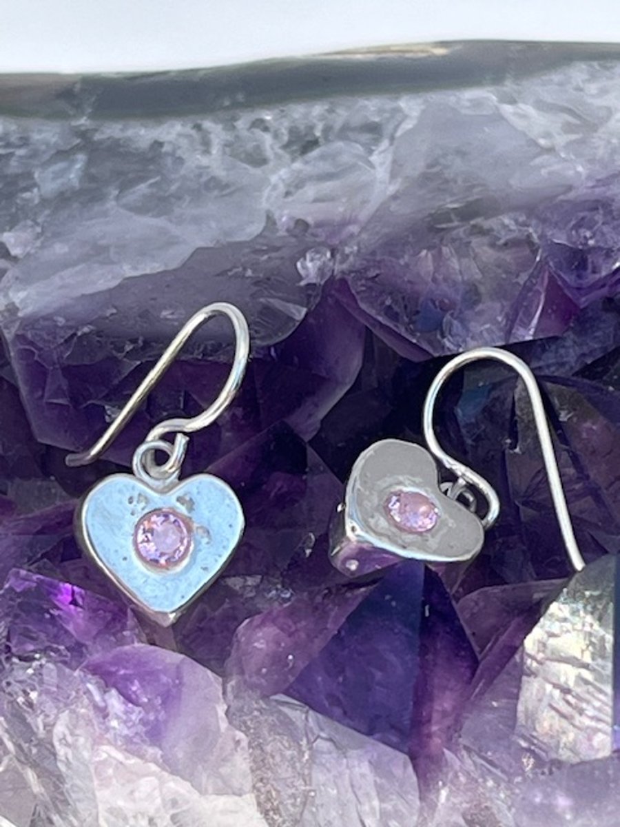 Silver heart earrings with pink CZ stone.