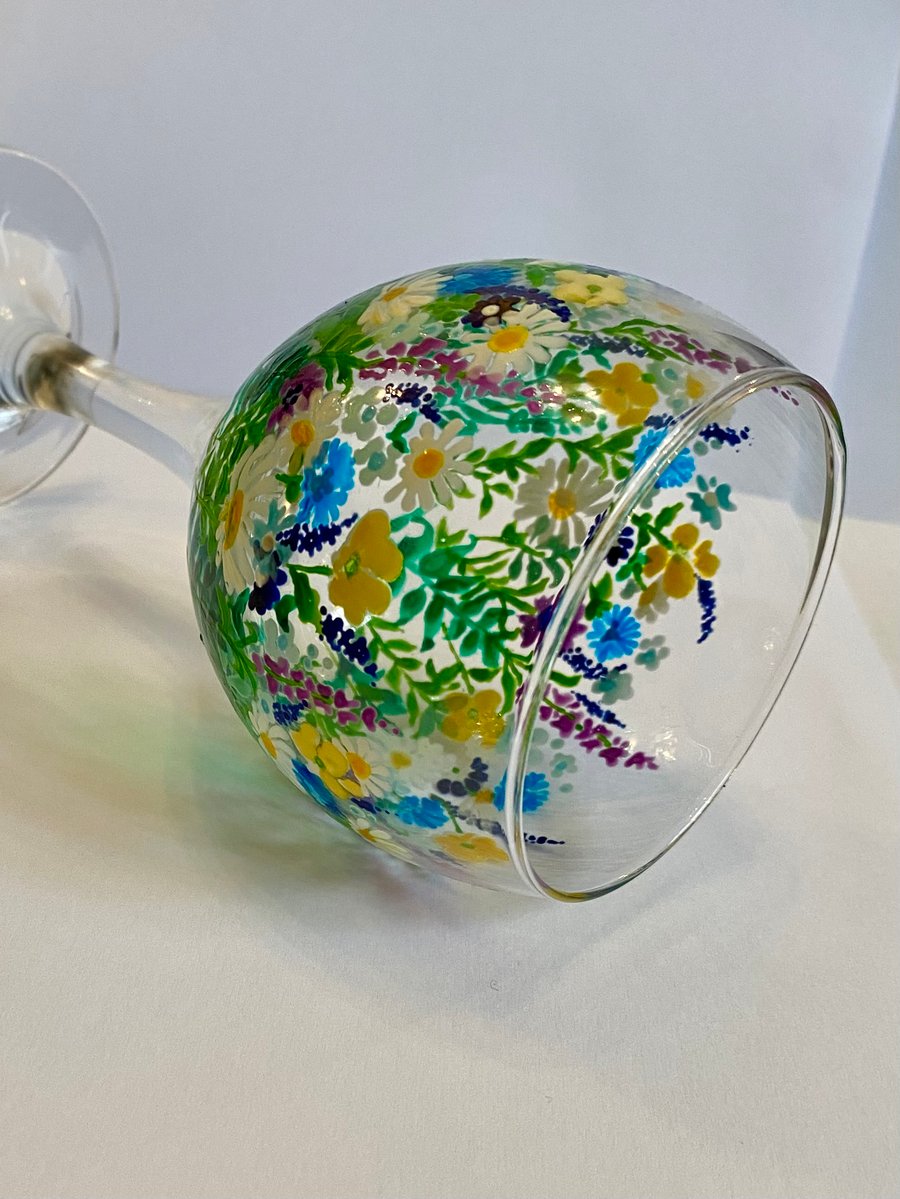 Hand painted floral design on wine glass