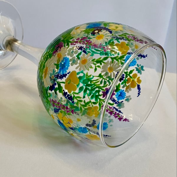 Hand painted floral design on wine glass