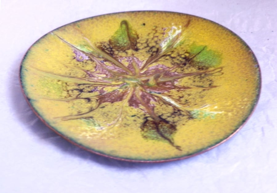 yellow dish decorated with scrolled pink, white and green pattern