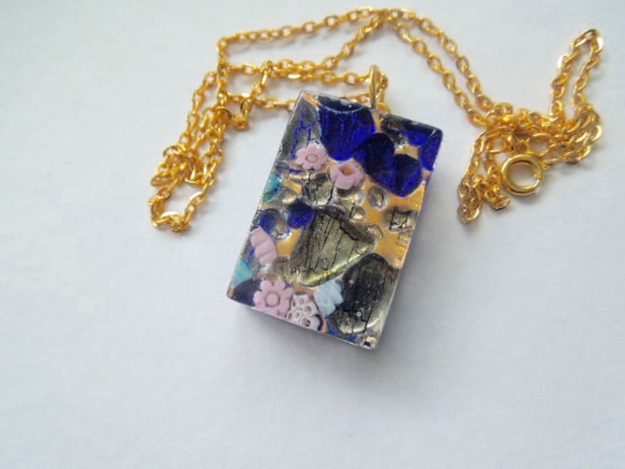Murano glass blue millefiore rectangular pendant with gold chain.