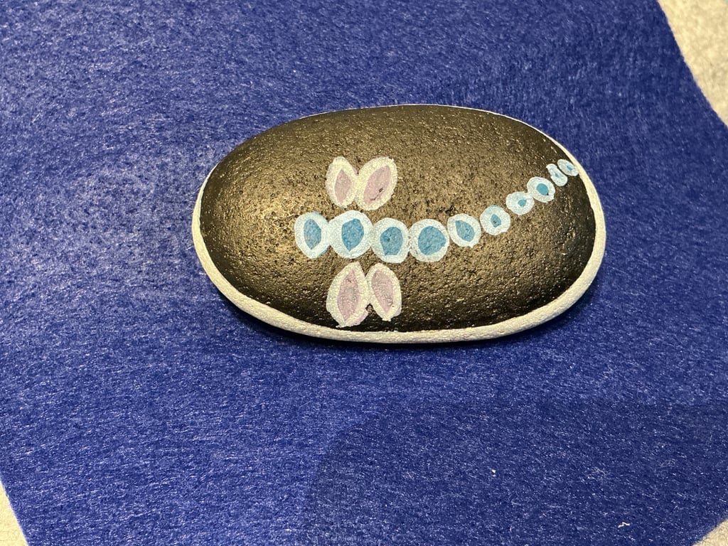 Hand painted pebble with dragonfly design.