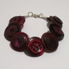 Cherry coloured button bracelet  	