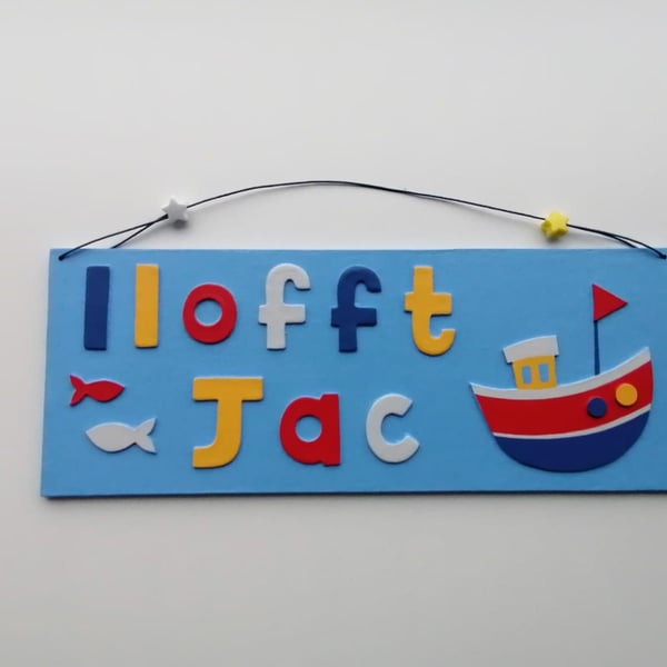 Welsh "Llofft" Boat themed personalised name plate with sky blue background.