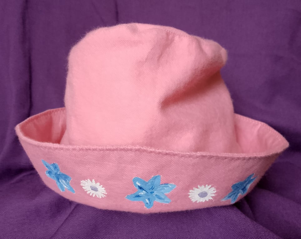Pink children's hat with hand painted flowers.