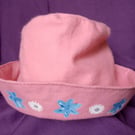 Pink children's hat with hand painted flowers.