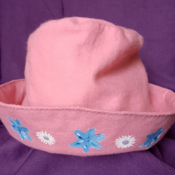 Pink children's hat with hand painted flowers.