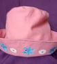 Pink children's hat with hand painted flowers.