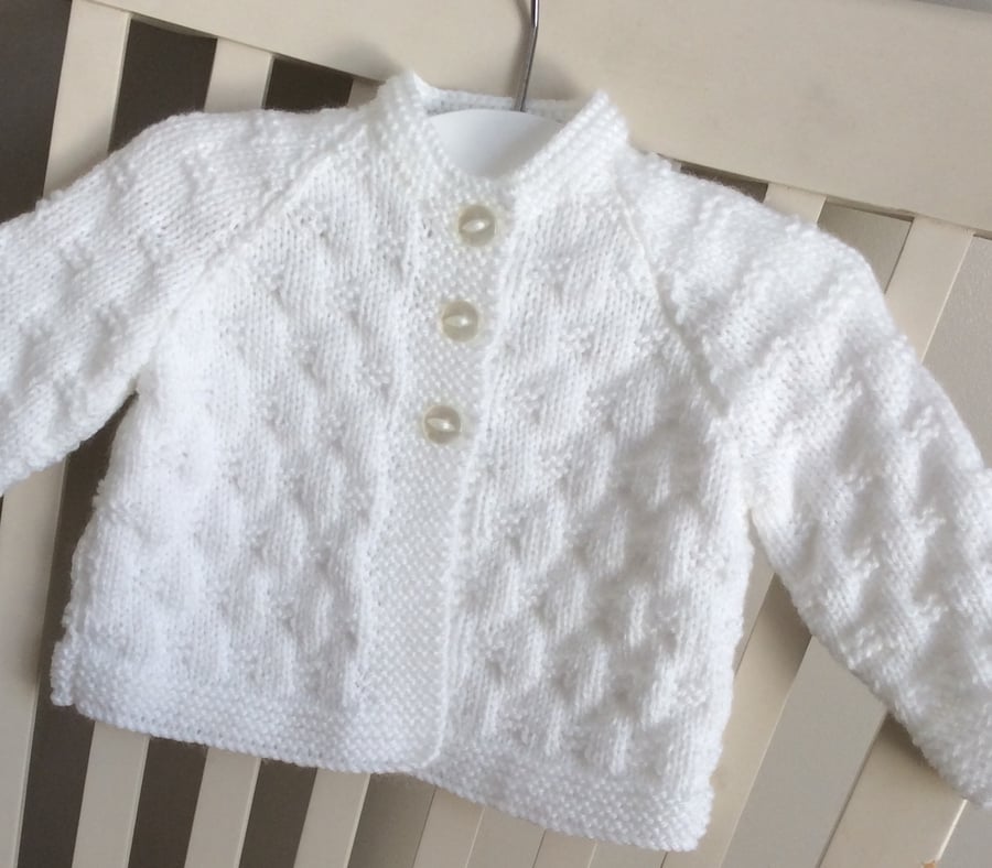 Hand knitted white baby cardigan