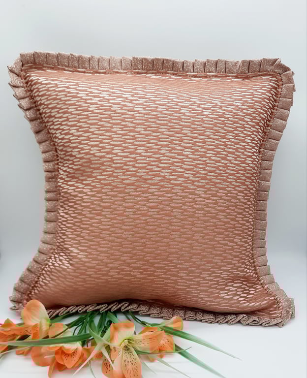 Coral textured cushion cover with a pleated edge. 