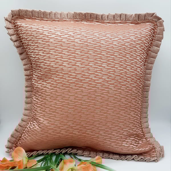 Coral textured cushion cover with a pleated edge. 