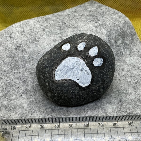 Hand painted pebble with paw print design